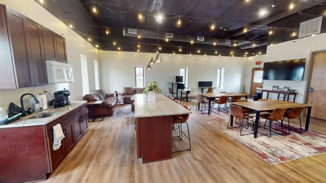 Common area with kitchen, lounge, and workspace
