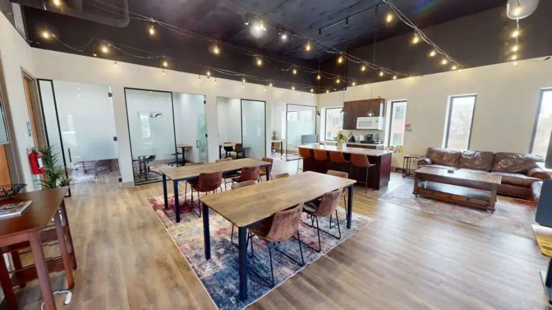 Main co-working floor with open desks and private offices